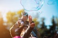 Children catch soap bubbles with their hands at a street party