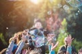 Children catch soap bubbles with their hands at a street party