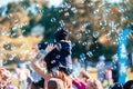 Children catch soap bubbles with their hands at a street party