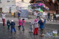 Children catching giant soap bubbles