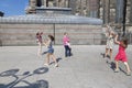Children catching soap bubbles in the street near of the Cologne Cathedral