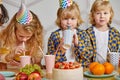 Children celebrate a birthday. party, smiles, kids near the table with a cake