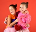 Children celebrate Valentines day. Sisters with furry and soft hearts