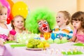 Children celebrating birthday party with clown Royalty Free Stock Photo