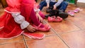 Children change their shoes to play on the playground, which is inside the room, children`s room