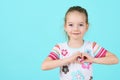 Children, Charity, Healthcare, Adoption Concept. Smiling little girl making heart-shape gesture.