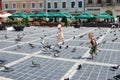 Children chasing pigeons