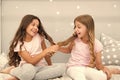 Children cheerful play with hair in bedroom. Happy childhood moments. Kids girls sisters best friends full of energy in