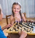 Children at chess board indoors Royalty Free Stock Photo