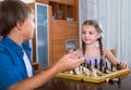 Children at chess board indoors Royalty Free Stock Photo