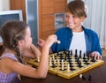 Children at chess board indoors Royalty Free Stock Photo