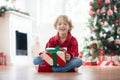 Child at Christmas tree. Kids at fireplace on Xmas Royalty Free Stock Photo
