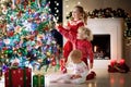 Children at Christmas tree. Kids at fireplace on Xmas eve Royalty Free Stock Photo