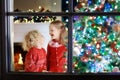 Children at Christmas tree. Kids at fireplace on Xmas eve Royalty Free Stock Photo