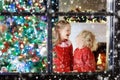 Children at Christmas tree. Kids at fireplace on Xmas eve Royalty Free Stock Photo