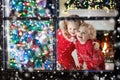 Children at Christmas tree. Kids at fireplace on Xmas eve Royalty Free Stock Photo