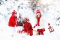 Children with Christmas tree. Snow winter fun for kids. Royalty Free Stock Photo