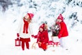 Children with Christmas tree. Snow winter fun for kids. Royalty Free Stock Photo