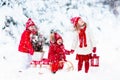 Children with Christmas tree. Snow winter fun for kids. Royalty Free Stock Photo