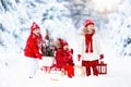 Children with Christmas tree. Snow winter fun for kids. Royalty Free Stock Photo