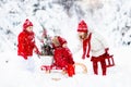 Children with Christmas tree. Snow winter fun for kids. Royalty Free Stock Photo