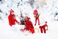 Children with Christmas tree. Snow winter fun for kids. Royalty Free Stock Photo