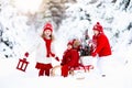 Children with Christmas tree. Snow winter fun for kids. Royalty Free Stock Photo