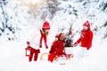 Children with Christmas tree. Snow winter fun for kids. Royalty Free Stock Photo