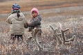 Children of Chukchi reindeer herders walk along the autumn tundra
