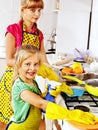 Children cleaning kitchen.