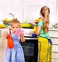 Children cleaning kitchen.