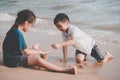 Children cleaning up garbage on the beach for enviromental clean up concept Royalty Free Stock Photo