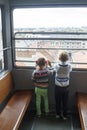 children climb in an empty funicular and look at the panorama of the city of Zagreb Royalty Free Stock Photo