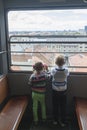 children climb in an empty funicular and look at the panorama of the city of Zagreb