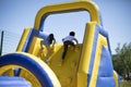 Children climb an inflatable slide. Inflatable obstacle course for fun