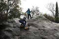 Children climb rock in park