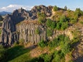 Children, climbing on a polygonal structures of basalt columns, natural monument Panska skala near Kamenicky Senov, Czech Republic