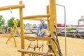 Selective focus. The children climbing and sliding on slide in the playground Royalty Free Stock Photo