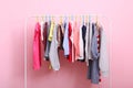 Children clothes on a hanger on a colored background. Royalty Free Stock Photo