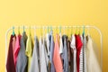 Children clothes on a hanger on a colored background. Royalty Free Stock Photo