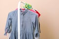 Children clothes on a hanger on a colored background. Royalty Free Stock Photo