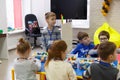 Children collect various objects from plastic parts of the constructor