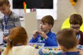 Children collect various objects from plastic parts of the constructor