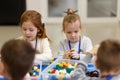 Children collect various objects from plastic parts of the constructor