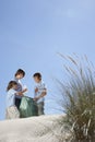 Children Collecting Bottle In Plastic Bag On Beach Royalty Free Stock Photo