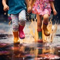 Children with colorful gum boots splashing water in muddy puddles.