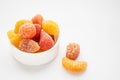 Children colorful gummy vitamins on white background. Multivitamin soft jelly candies in form of different kind of fruit.