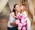 Children congratulate mother give her bouquet of flowers