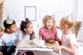 Children congratulate their friend with birthday