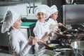 Children cook eggs in the kitchen at the Restaurant.